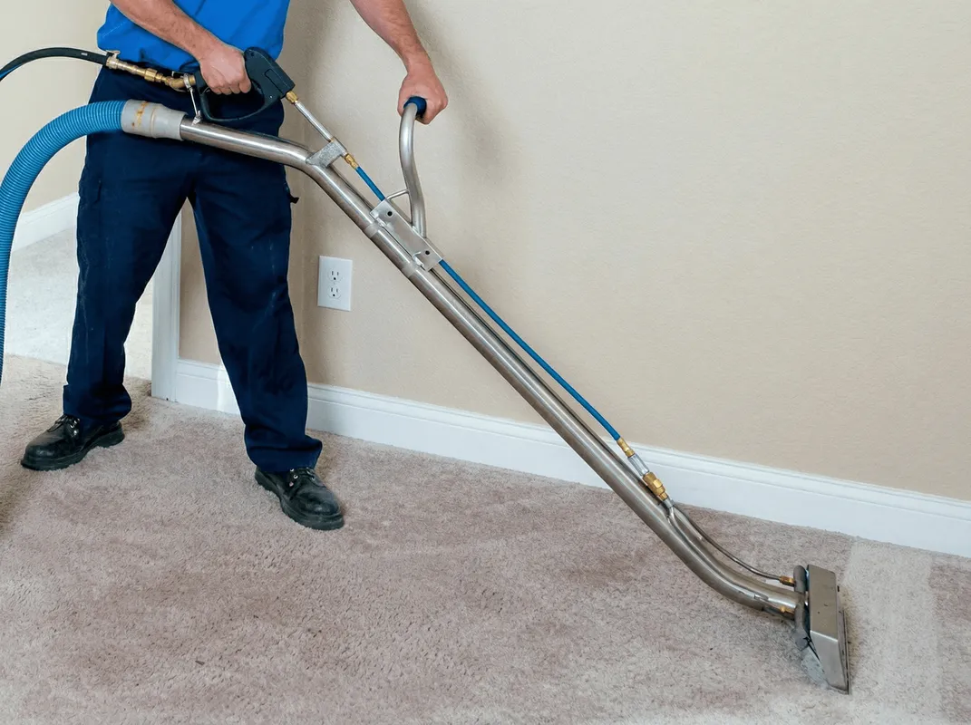 Professional operating a liquid removal machine on a carpeted floor in Miami, FL